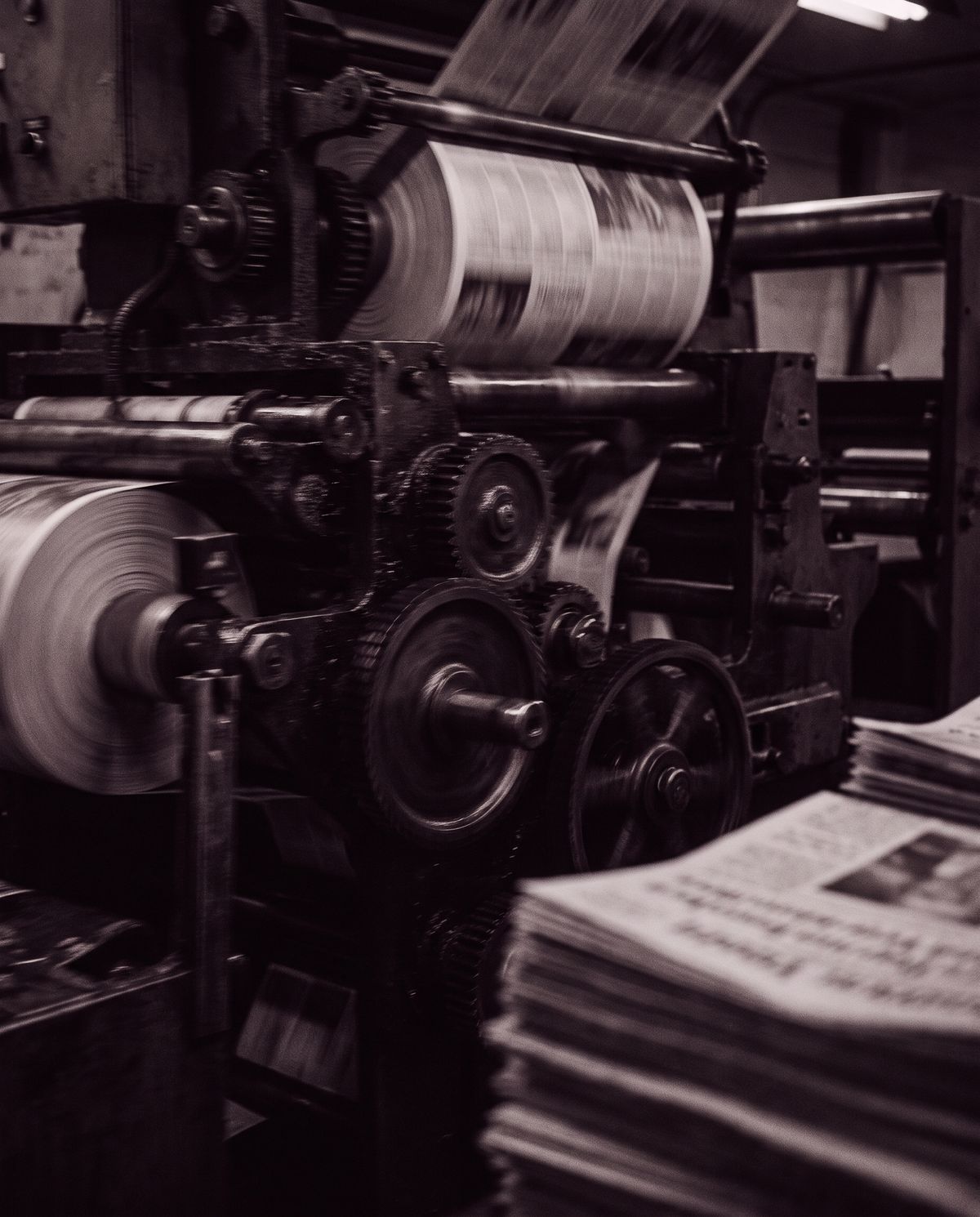 A newspaper printing press running at speed